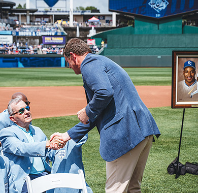The inductees of the Royals Hall of Fame shaking hands with the presenter.