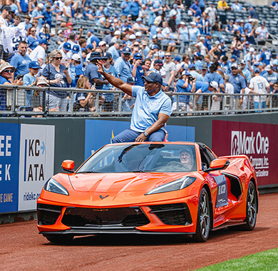 Bo Jackson in a vehicle waving to a crowd.